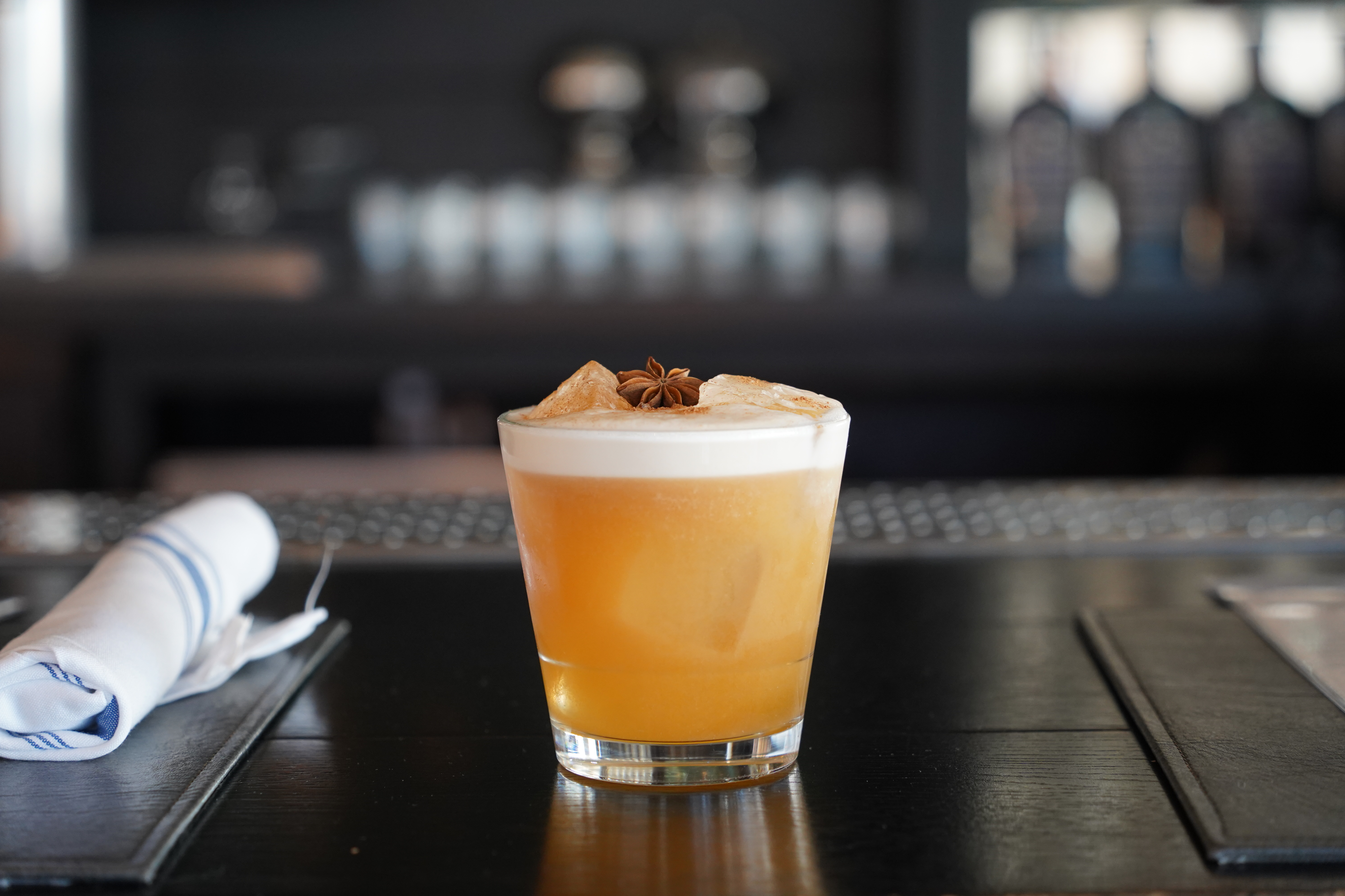 Whiskey sour on dark bar
